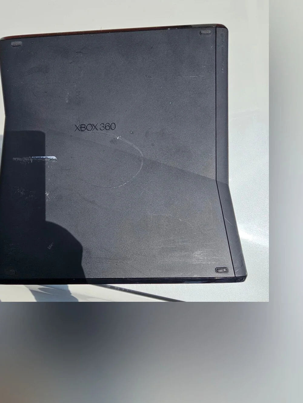 Microsoft Xbox 360 S (Slim) console, featuring a sleek black